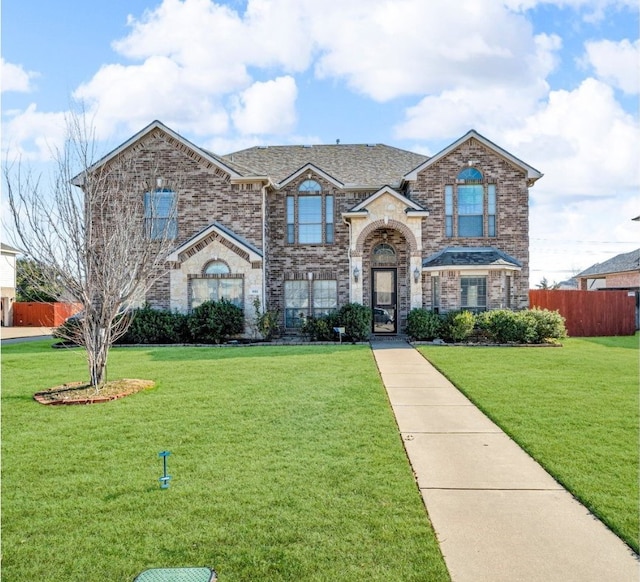 801 Sunrise Dr, Kennedale, TX 76060 - traditional home featuring brick siding, a front lawn, fence, and stone siding