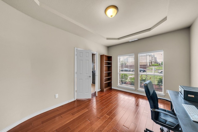 801 Sunrise Dr, Kennedale, TX 76060 - office area featuring baseboards, dark wood-style floors, and a tray ceiling
