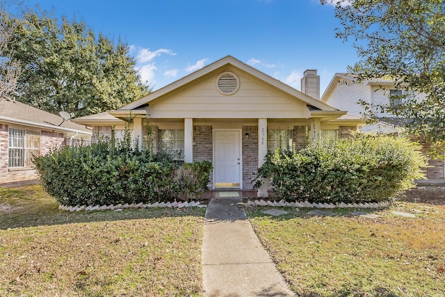 bungalow-style home featuring a front yard and covered porch