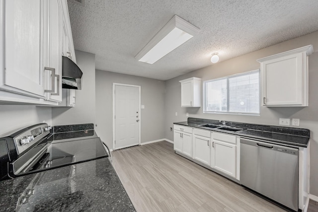 kitchen featuring stainless steel appliances, white cabinetry, and sink