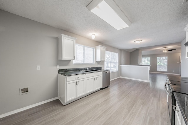 kitchen with white cabinetry, appliances with stainless steel finishes, a textured ceiling, and light hardwood / wood-style floors