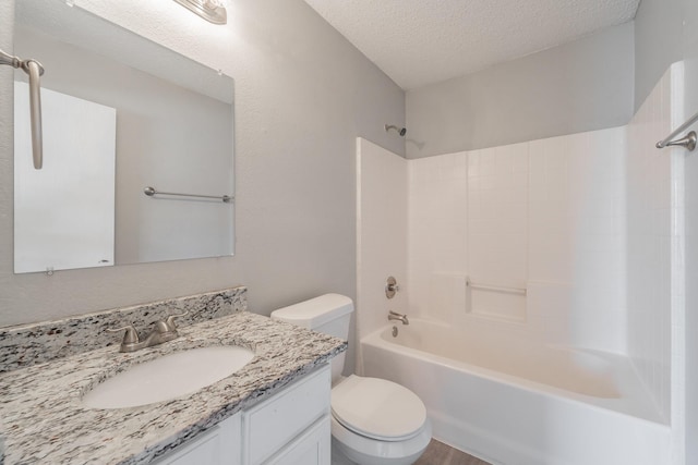 full bathroom featuring wood-type flooring, vanity, toilet, tub / shower combination, and a textured ceiling