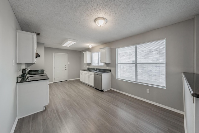 kitchen featuring sink, a textured ceiling, dishwasher, light hardwood / wood-style floors, and white cabinets