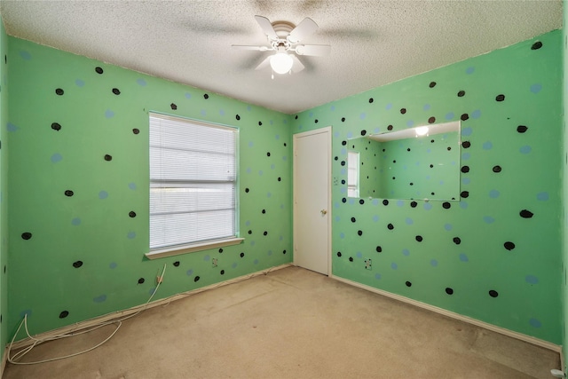 unfurnished bedroom with light carpet, a textured ceiling, and ceiling fan