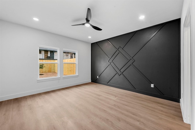 spare room featuring ceiling fan and light hardwood / wood-style floors