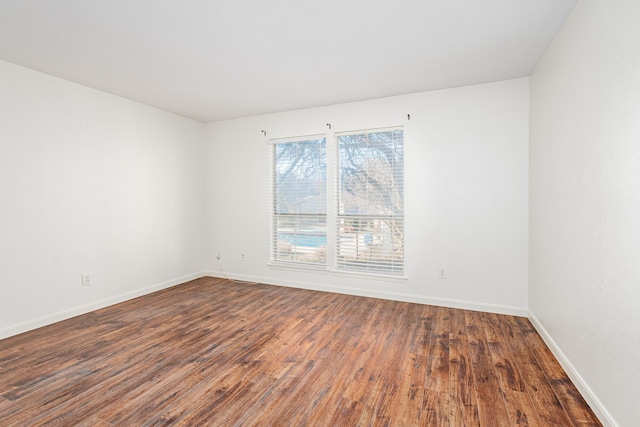 empty room with dark wood-type flooring