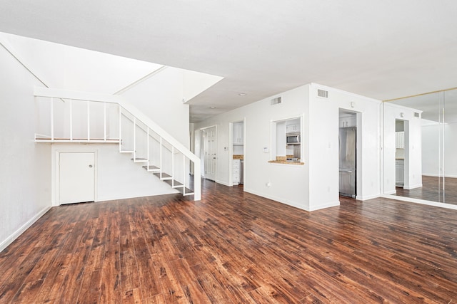 unfurnished living room with dark hardwood / wood-style floors