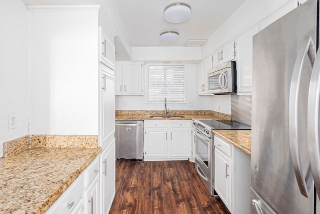 kitchen with white cabinetry, sink, stainless steel appliances, and dark hardwood / wood-style floors