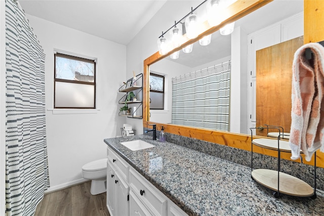 bathroom with a shower with shower curtain, vanity, toilet, and hardwood / wood-style floors