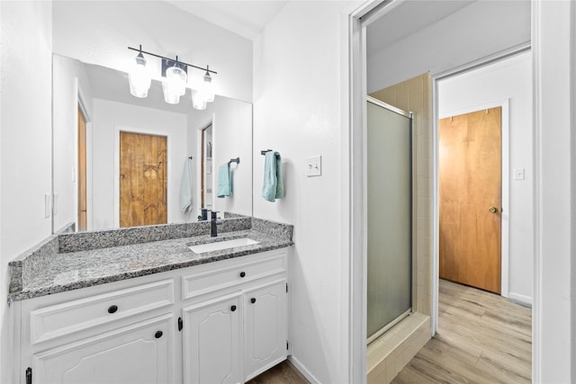 bathroom featuring vanity, hardwood / wood-style flooring, and walk in shower