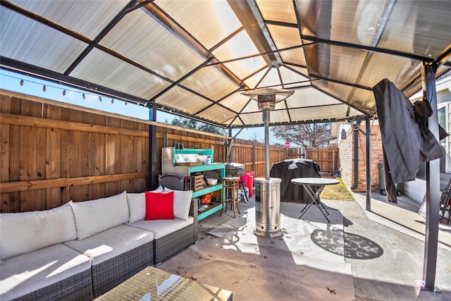 view of patio with an outdoor living space and a gazebo