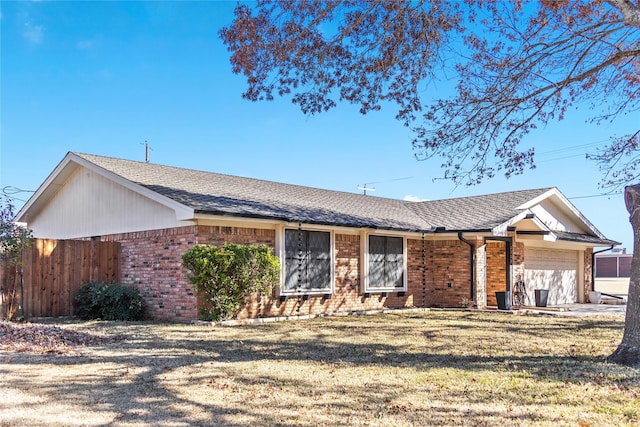 ranch-style house featuring a garage and a front lawn