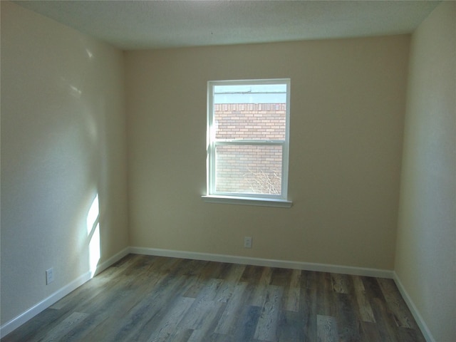 empty room featuring dark hardwood / wood-style flooring