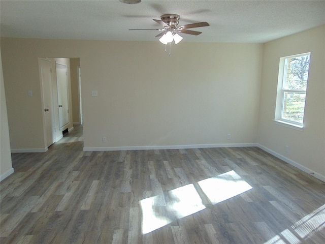 empty room featuring hardwood / wood-style floors and ceiling fan