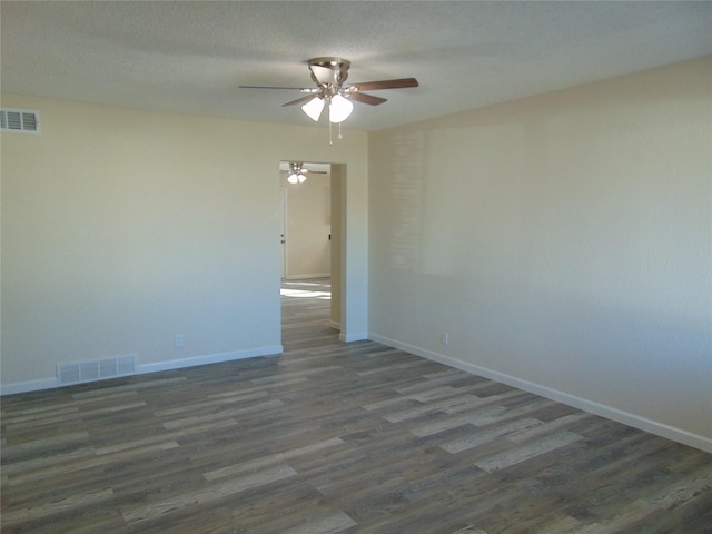 spare room featuring a textured ceiling, dark hardwood / wood-style floors, and ceiling fan