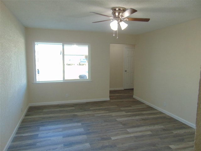 spare room featuring dark hardwood / wood-style floors and ceiling fan