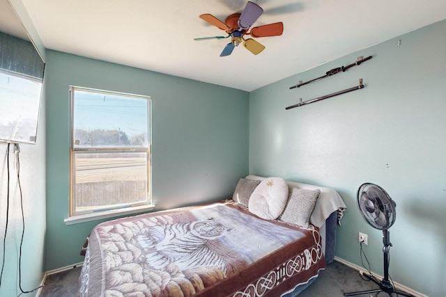 bedroom with ceiling fan and dark carpet