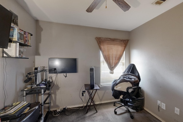 carpeted office with ceiling fan