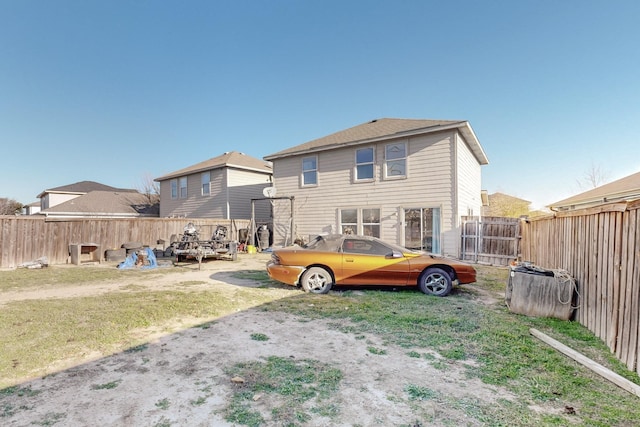 back of house featuring a yard