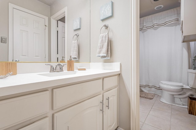 bathroom featuring tile patterned flooring, vanity, walk in shower, and toilet