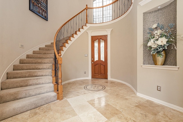 foyer entrance featuring a healthy amount of sunlight and a high ceiling