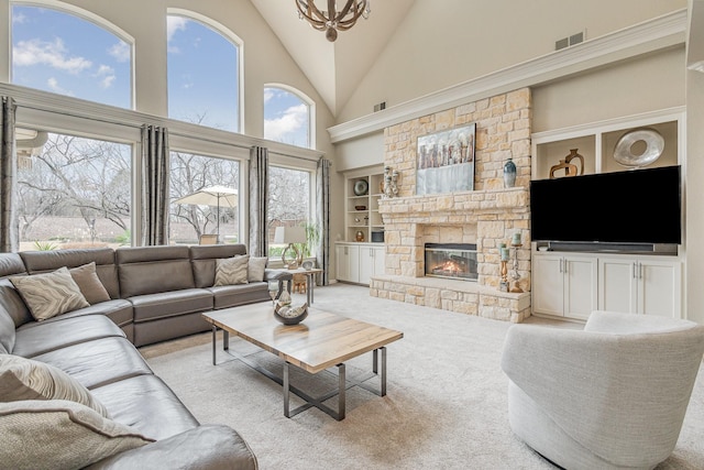 living room with built in shelves, light colored carpet, a fireplace, and high vaulted ceiling