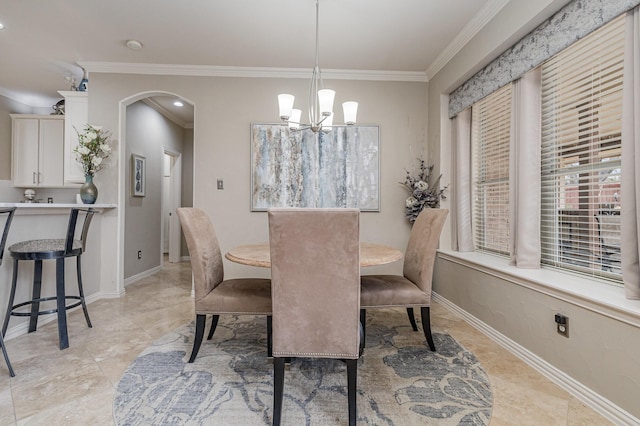 dining area with ornamental molding and a notable chandelier