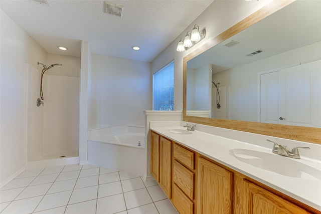 bathroom featuring tile patterned floors, plus walk in shower, vanity, and a textured ceiling