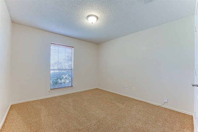 unfurnished room with carpet floors and a textured ceiling