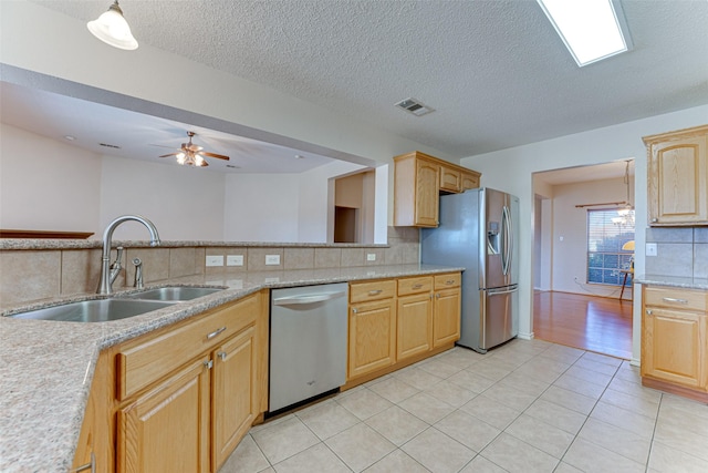 kitchen featuring light tile patterned flooring, stainless steel appliances, sink, and backsplash