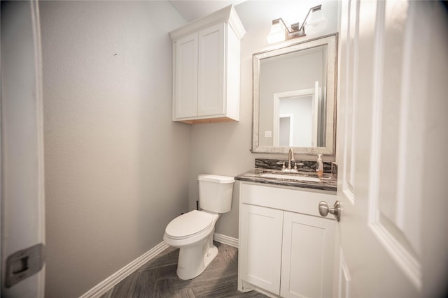 bathroom featuring hardwood / wood-style flooring, vanity, and toilet