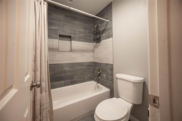 bathroom featuring shower / bathtub combination with curtain and toilet