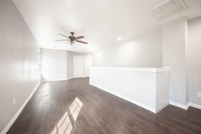 spare room featuring ceiling fan and dark hardwood / wood-style flooring