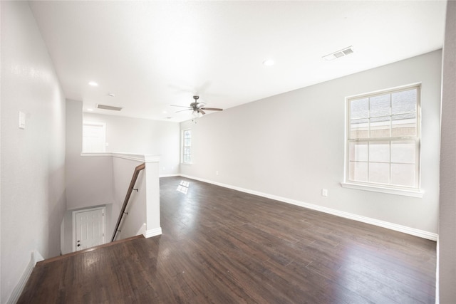 unfurnished room with dark wood-type flooring, plenty of natural light, and ceiling fan