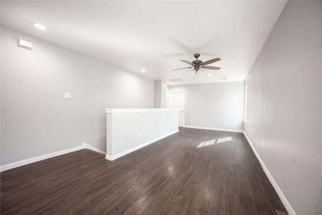 empty room with ceiling fan and dark hardwood / wood-style floors