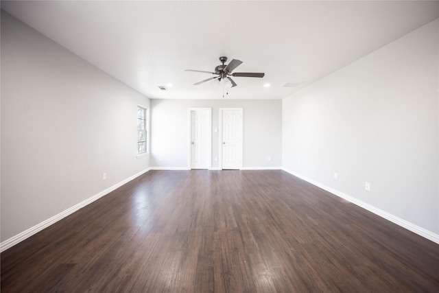 empty room with dark hardwood / wood-style floors and ceiling fan