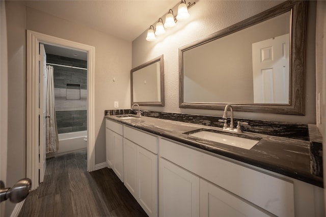 full bathroom featuring wood-type flooring, toilet, vanity, and shower / bath combo with shower curtain