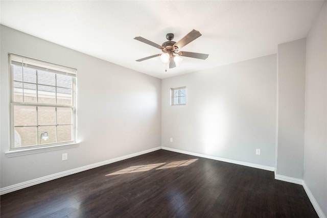 spare room with dark hardwood / wood-style floors and ceiling fan