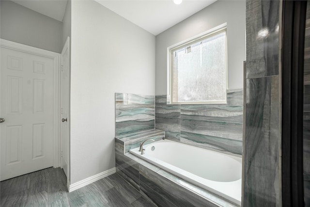 bathroom featuring tiled bath