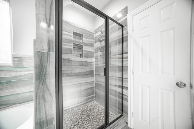 bathroom with a shower with door