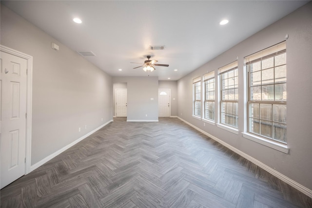 unfurnished room featuring ceiling fan and dark parquet floors