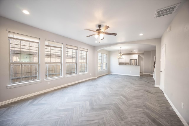 unfurnished living room with parquet floors and ceiling fan