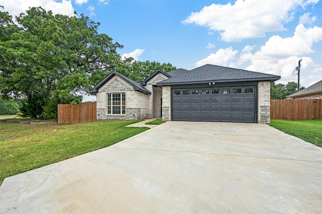 view of front of home with a front yard, concrete driveway, and fence