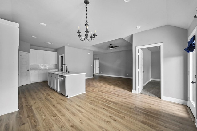 kitchen featuring pendant lighting, light wood-type flooring, white cabinetry, and decorative backsplash