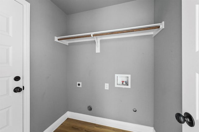 washroom with dark wood-style flooring, hookup for a washing machine, hookup for an electric dryer, laundry area, and baseboards