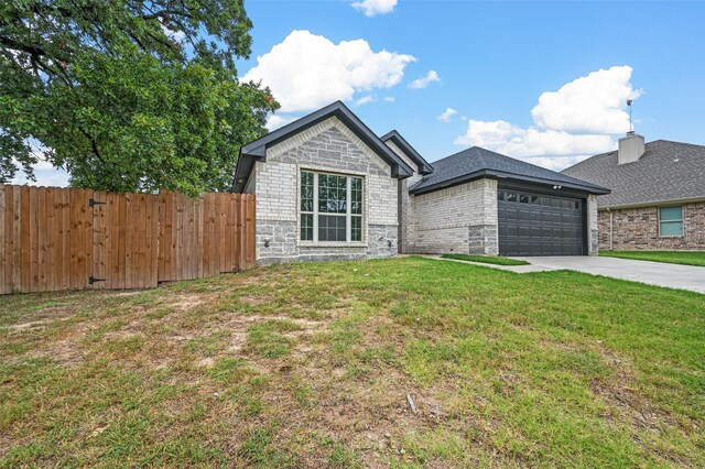 single story home with a garage and a front yard