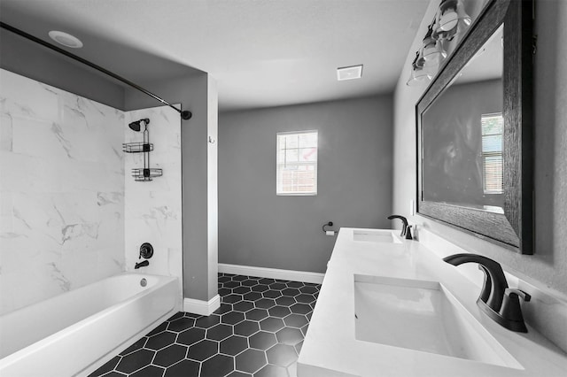 bathroom with  shower combination, baseboards, visible vents, and a sink