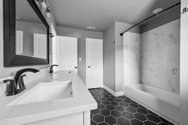 bathroom with visible vents, a sink, shower / bathing tub combination, and double vanity