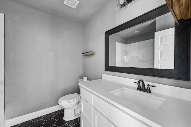 bathroom featuring visible vents, toilet, vanity, tile patterned flooring, and baseboards