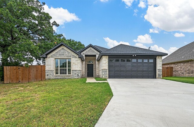 view of front of property with a garage and a front yard